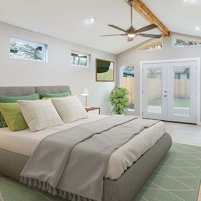 bright florida master bedroom with double doors to back porch