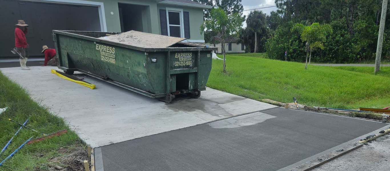 Cardinal Construction workers smoothing concrete driveway