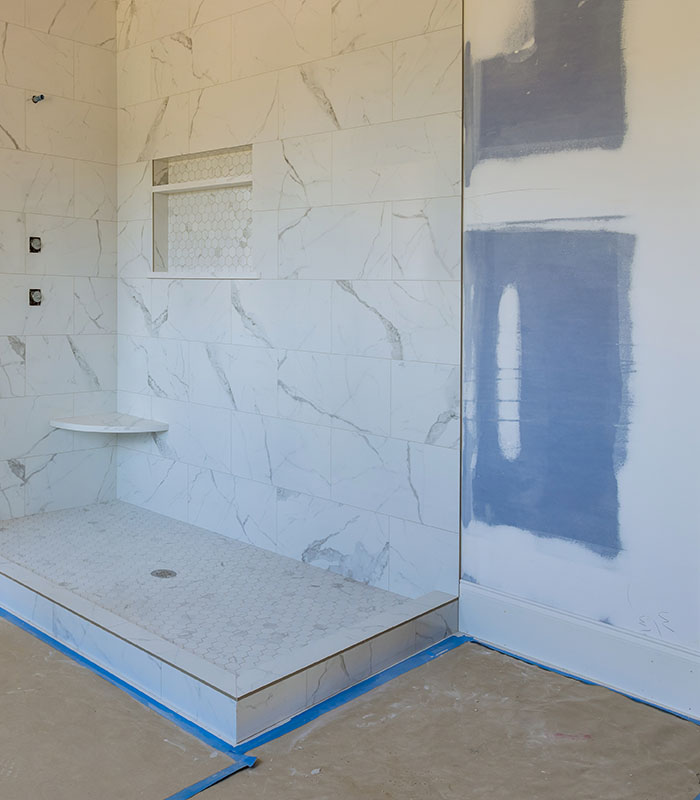 bathroom remodel showing shower completed but walls and floorign still under construction