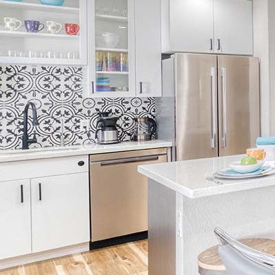 modern kitchen with white cabinets and stainless steel appliances