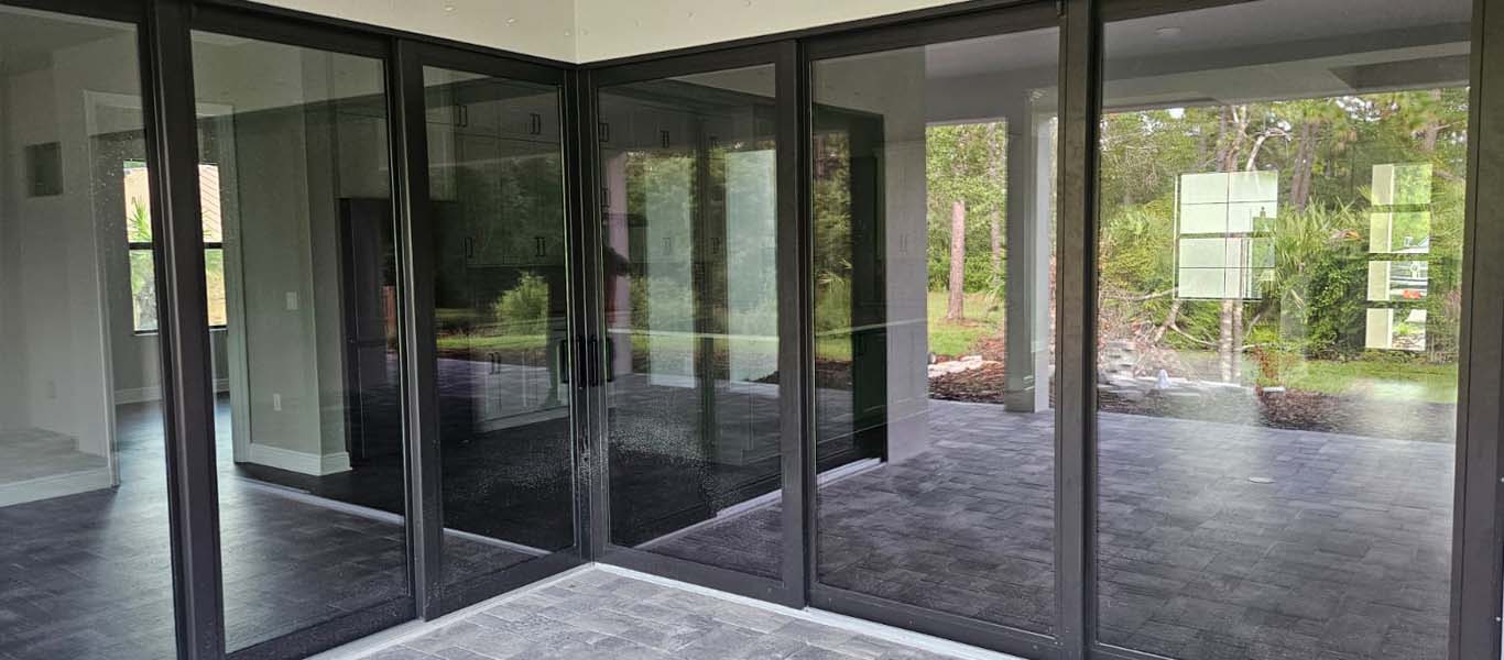 6 black sliding glass doors forming a V for a massive back patio